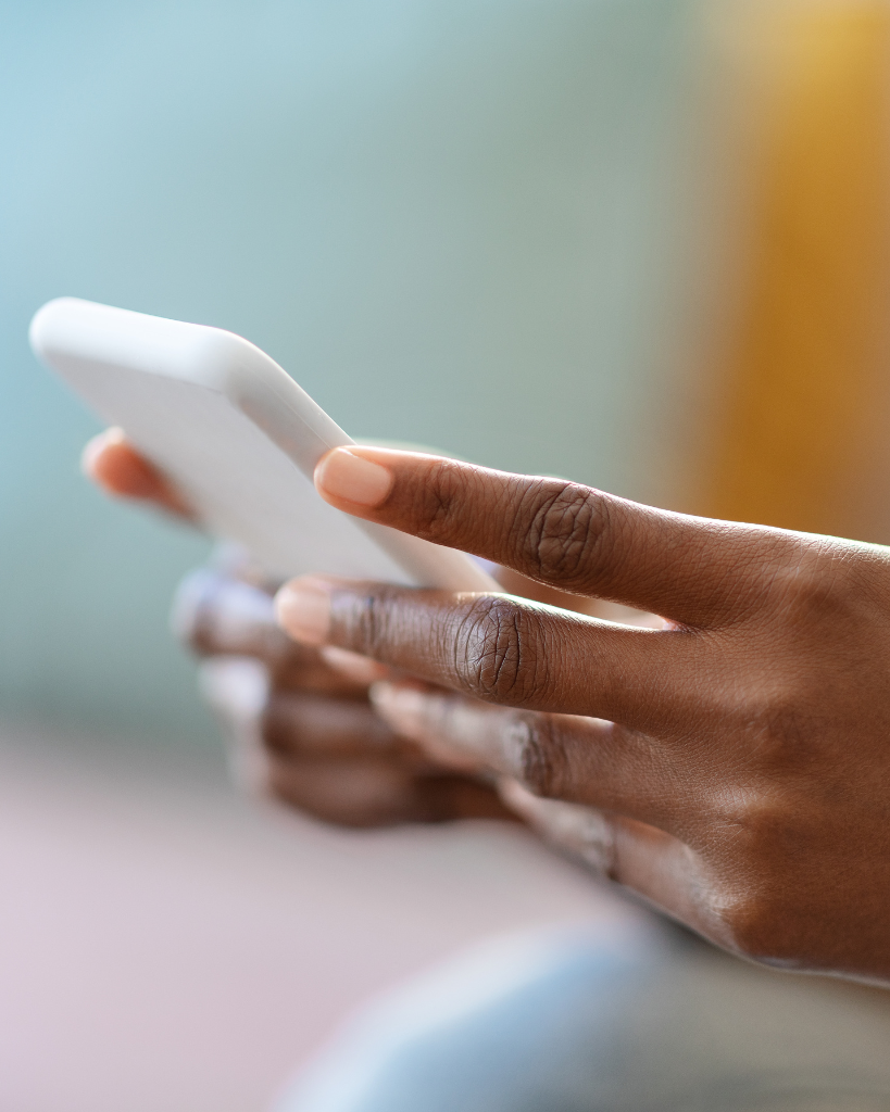 Black woman hands holding cell phone